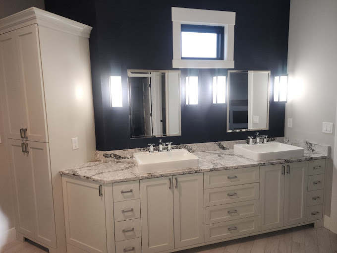 A bathroom with two sinks and two mirrors